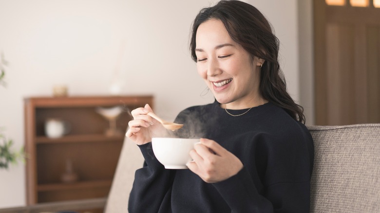 Woman eating soup