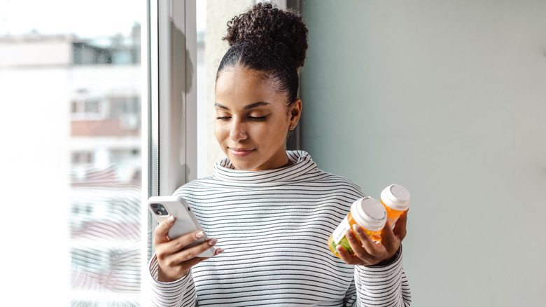 A woman holding supplements