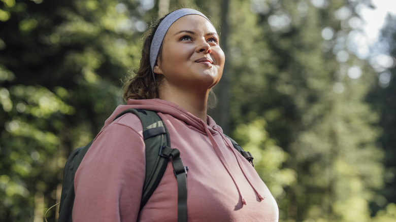 Woman smiles at trees