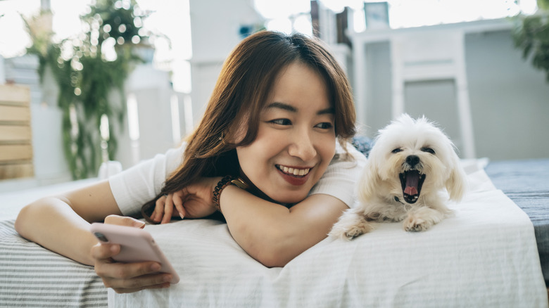 woman on bed with dog