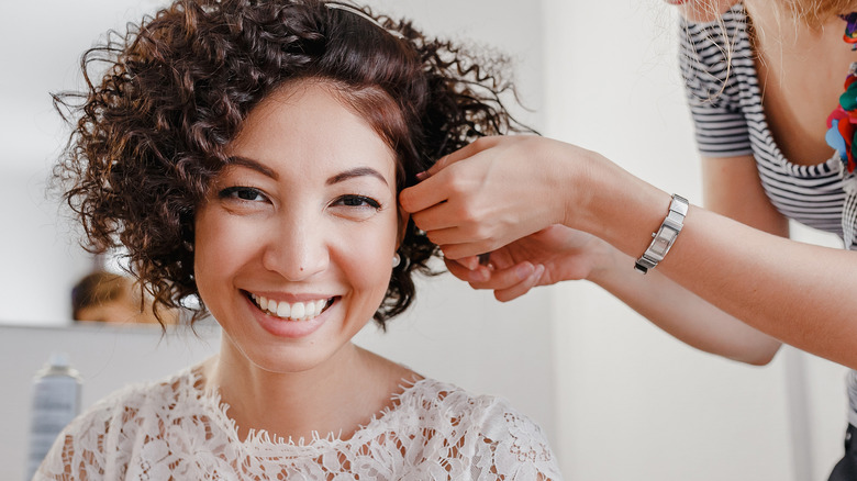 Bride getting her curly hair styled