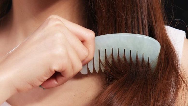 woman using white jade hair comb