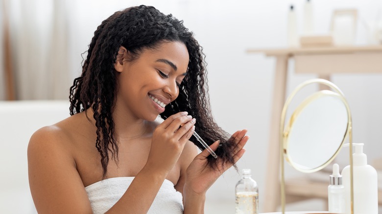 Woman using hair oil