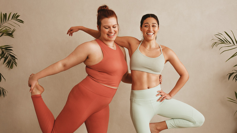 Two women stretching and smiling