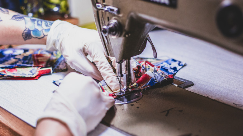 hands sewing with sewing machine