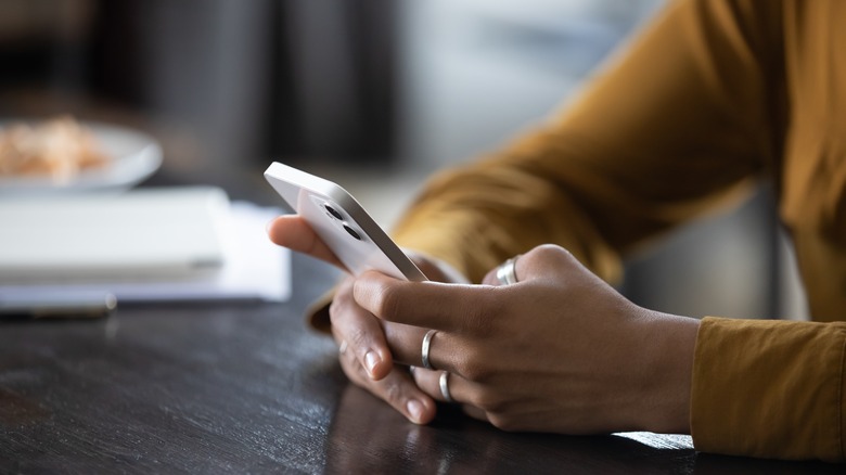 woman's hands holding phone