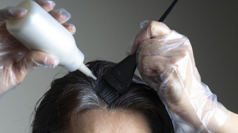 A woman dying her hair