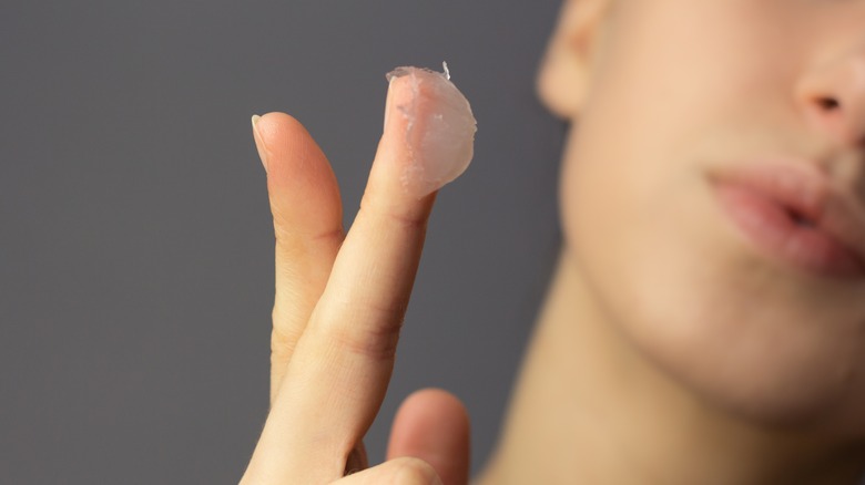 A woman with Vaseline on her finger