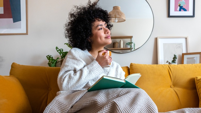 woman drinking coffee on couch