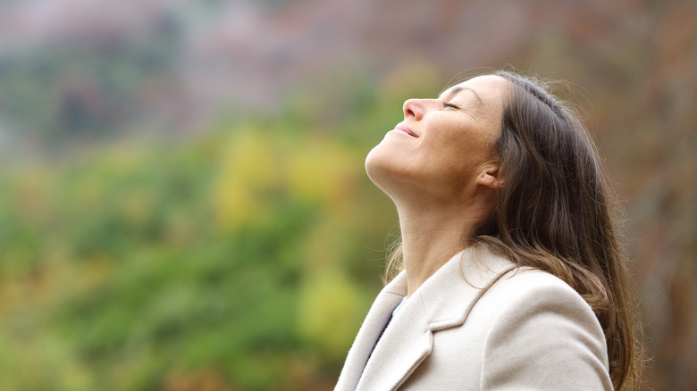 woman smiling at sky