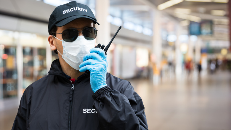 Airport security employee uses radio