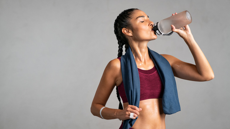 Sweaty woman drinking water