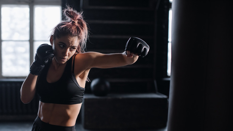 Woman punching heavy bag