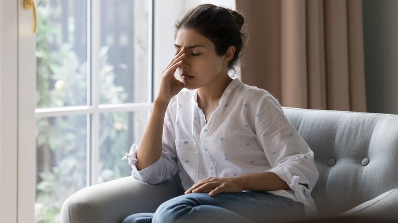 Frustrated woman on sofa