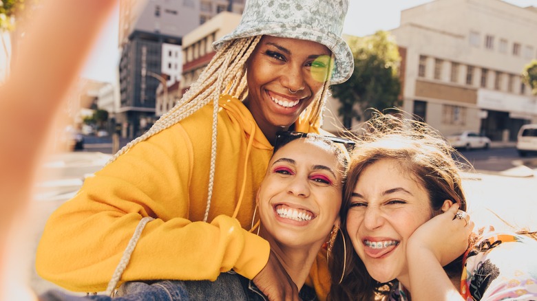 A group of friends smiling and taking a selfie