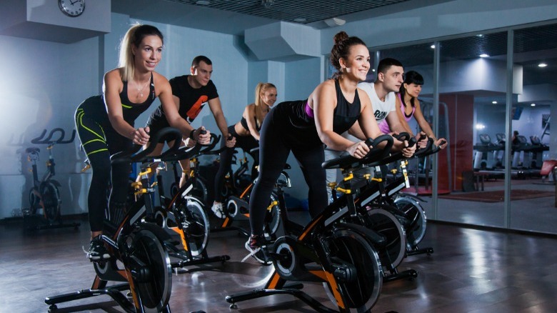 Group of women cycling indoors