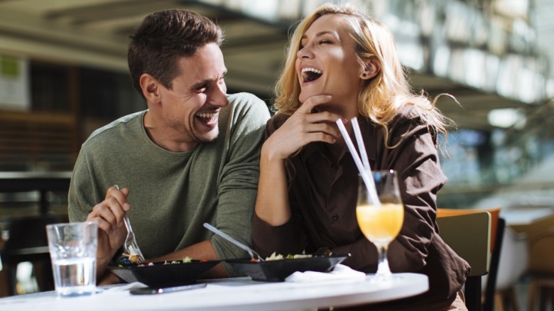 Man and woman laughing