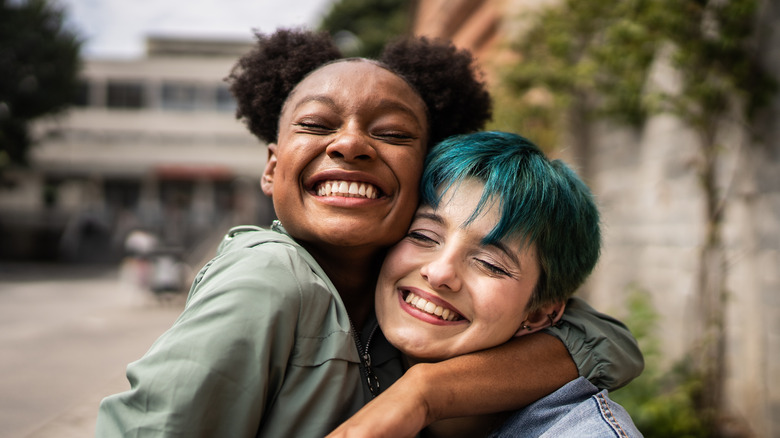 Happy women hugging outside