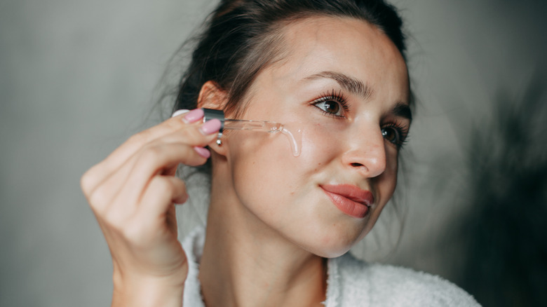 Woman applying retinol