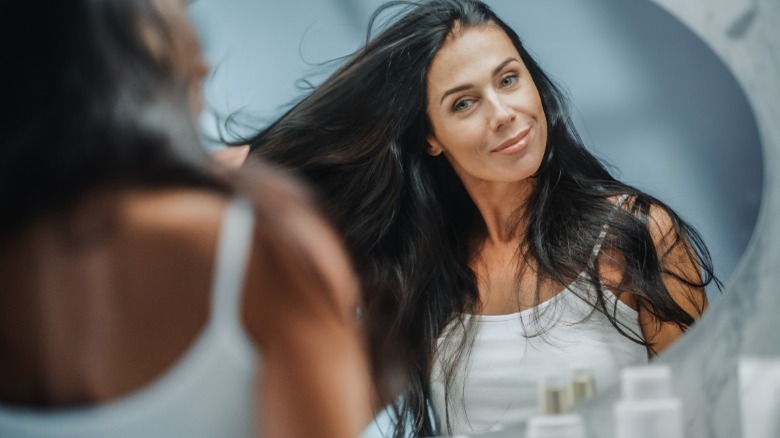 Woman admiring her long hair