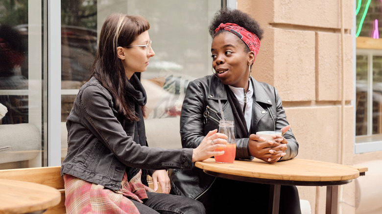 women talking at outdoor cafe