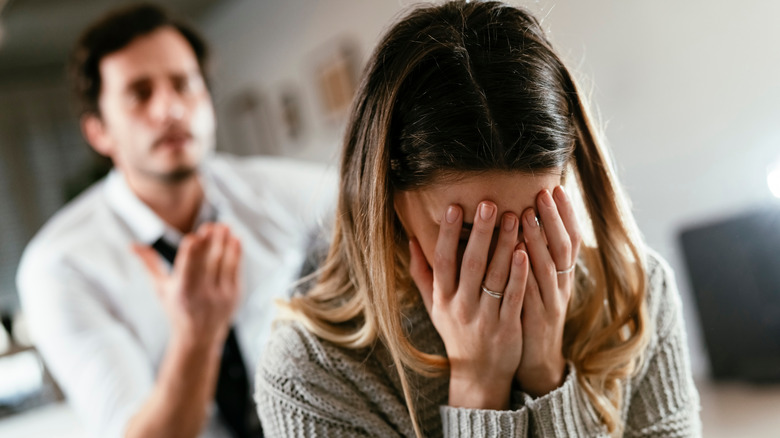 man yelling at sad woman