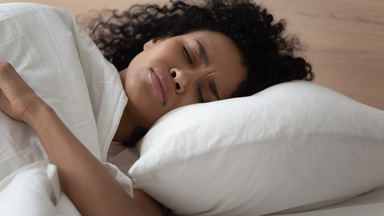 Woman looks concerned in sleep 