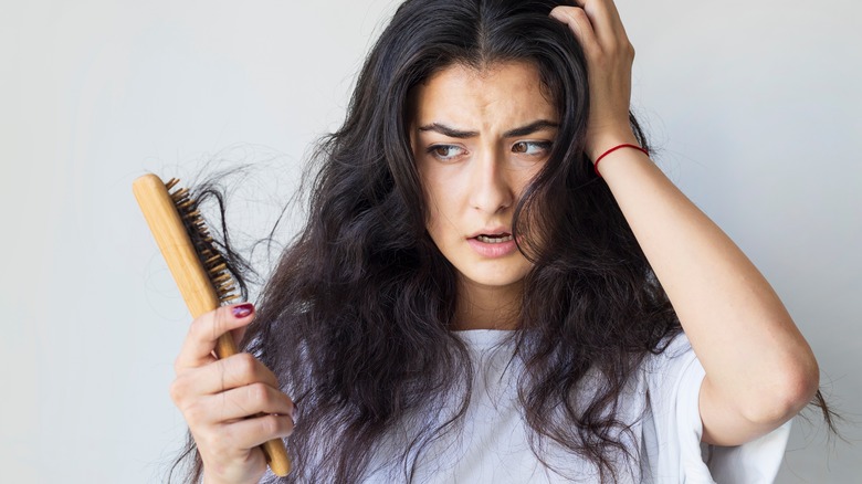 woman with damaged hair with brush