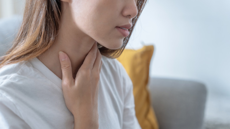 woman touching neck