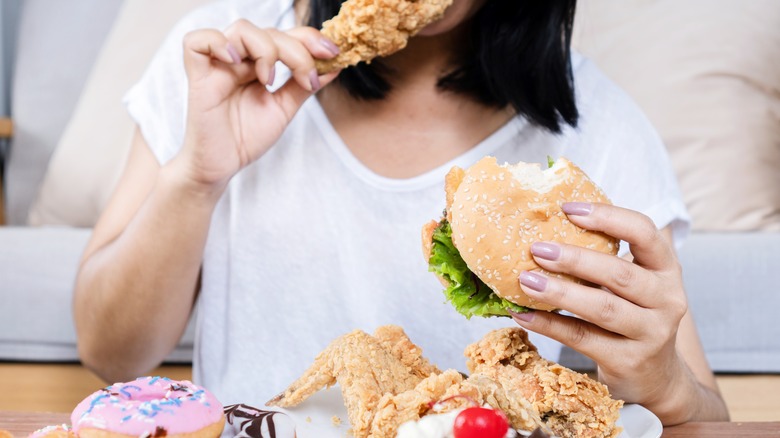 woman eating unhealthy meal