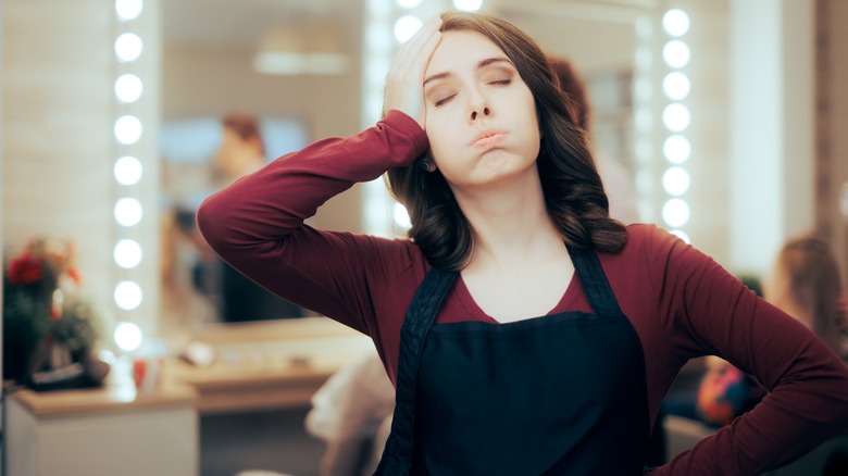 stressed hairstylist in salon