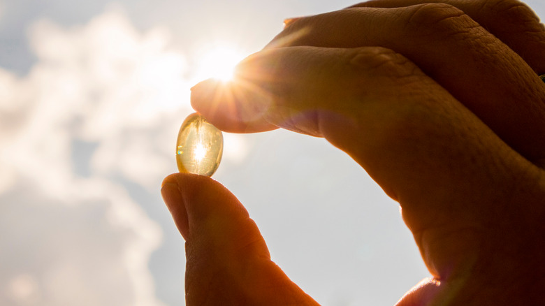 Model holding vitamin D capsule