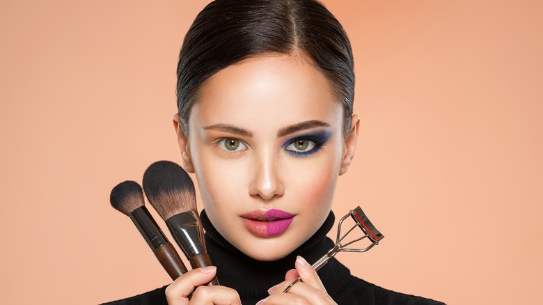 woman holding makeup tools