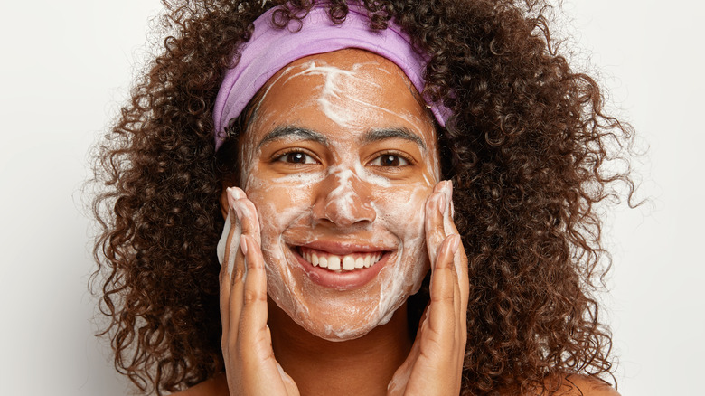 woman washing or exfoliating face