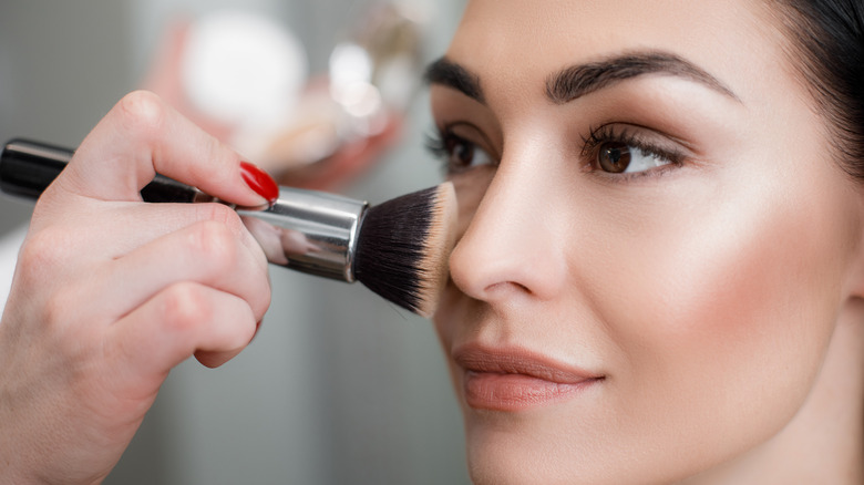 applying powder makeup to face