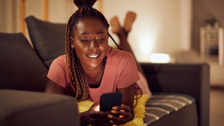 woman on phone on couch