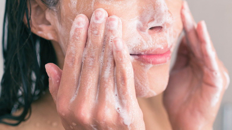 closeup of woman exfoliating face