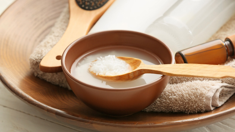 rice water in bowl next to cosmetics