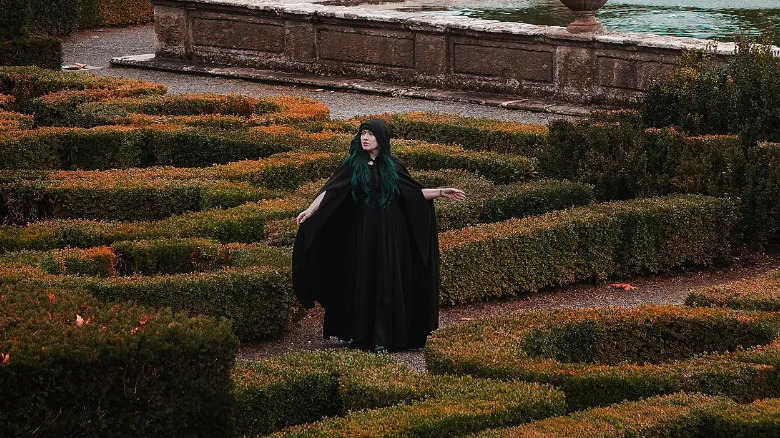 woman in black cloak