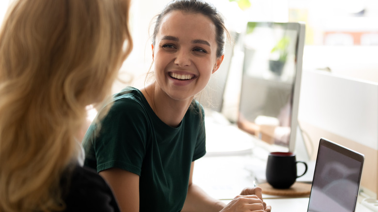 student smiling listening to boss