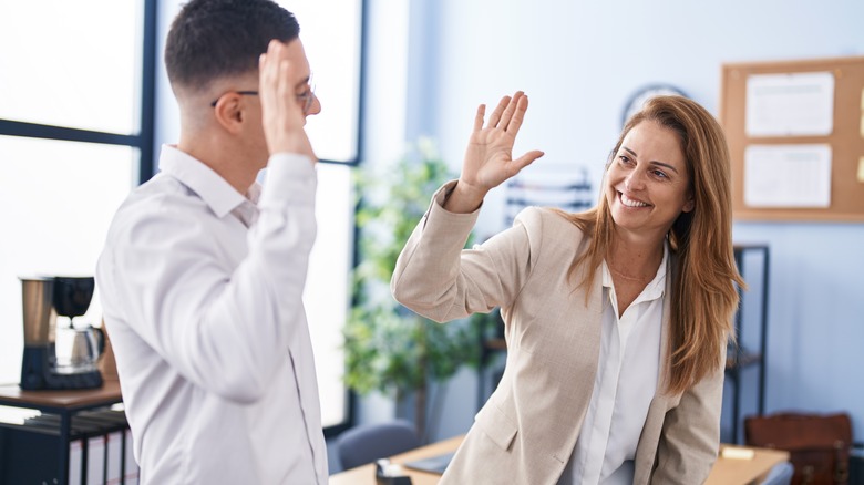 boss giving employee high five