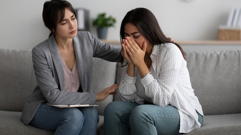 employer comforting woman going through breakdown