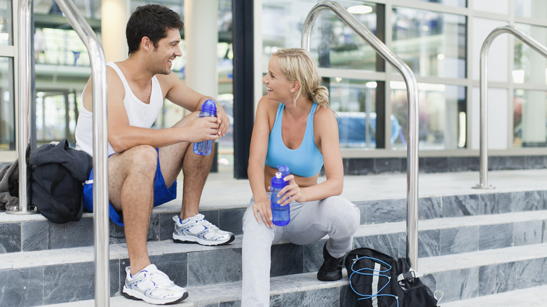 Man and woman talking at gym