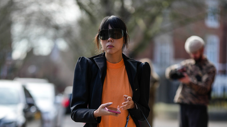 wraparound sunglasses with ruffled blazer