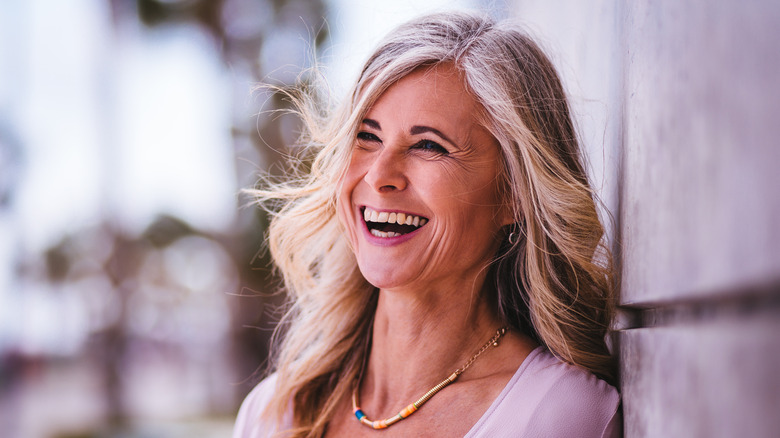 woman with waved hair smiling