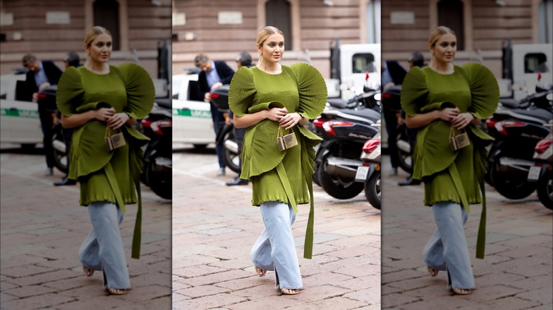 woman wearing green dress over jeans