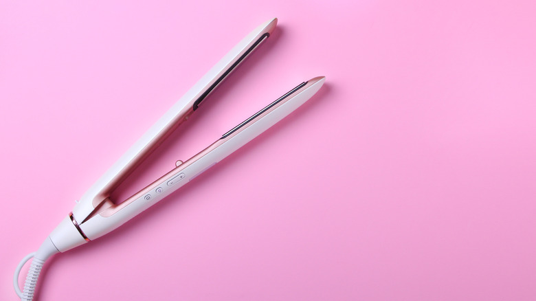 flat iron on pink background