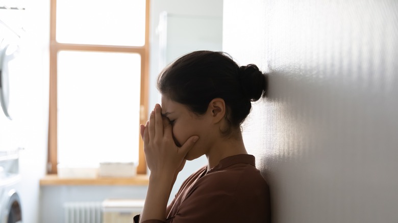 Young woman wiping tears