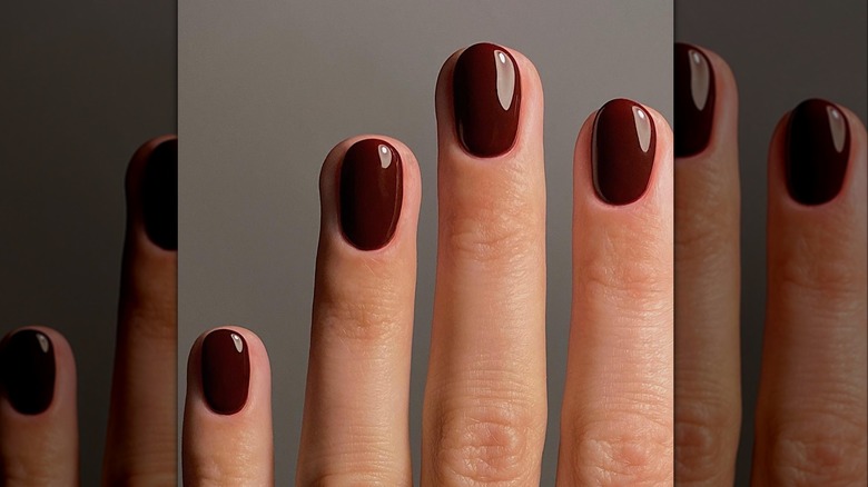 hand with burgundy nail polish