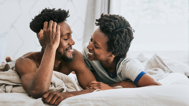 Smiling couple in bed